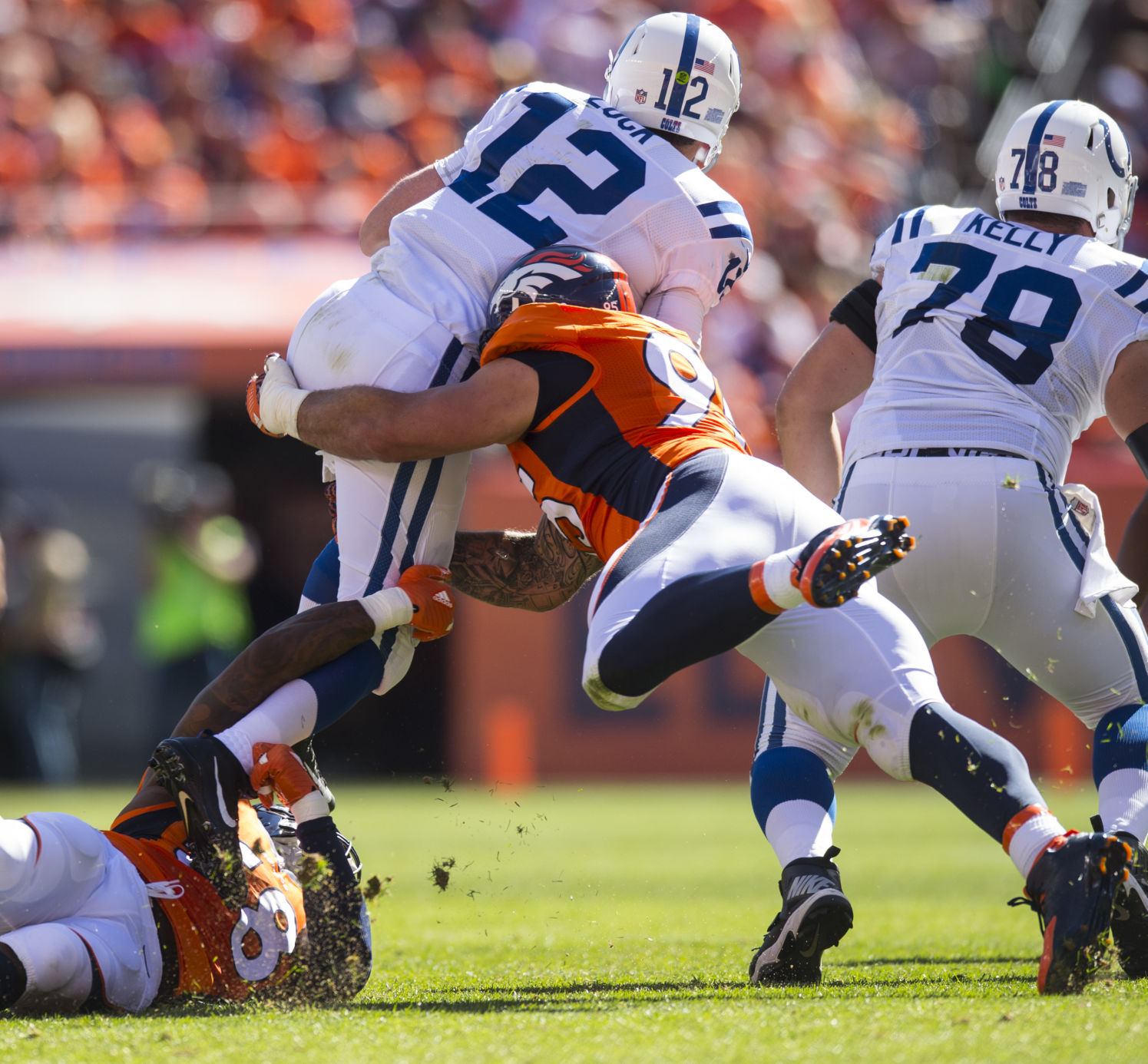 Broncos defensive linebacker Von Miller, bottom, and defensive end Derek Wolfe sack Colts quarterback Andrew Luck forcing a fourth down Sunday, Sept. 18, 2016, during the second quarter at Sports Authority Field at Mile High in Denver. (The Gazette, Chr...